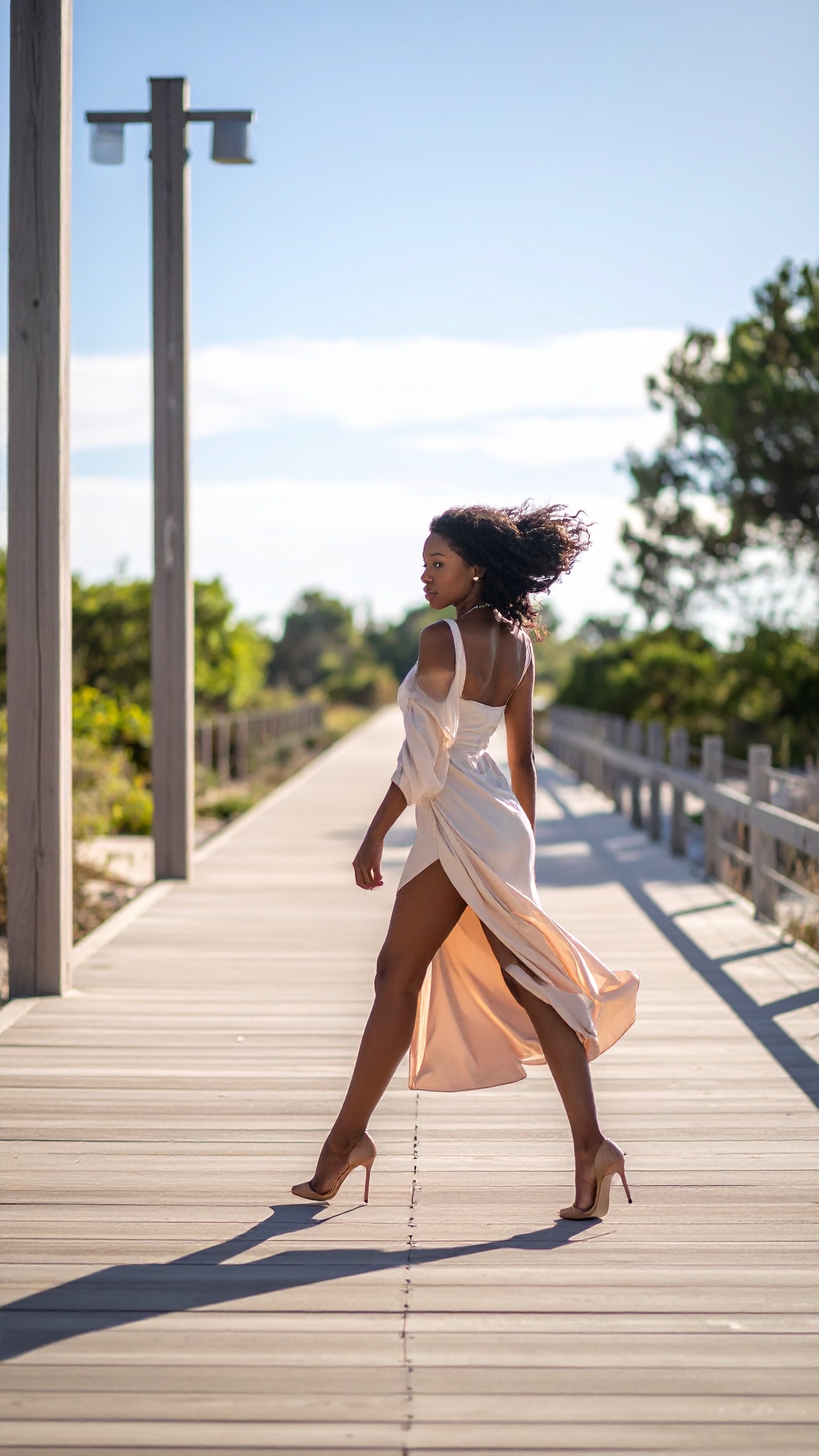 A dancer mid-step, fabric in motion, warm neutral room