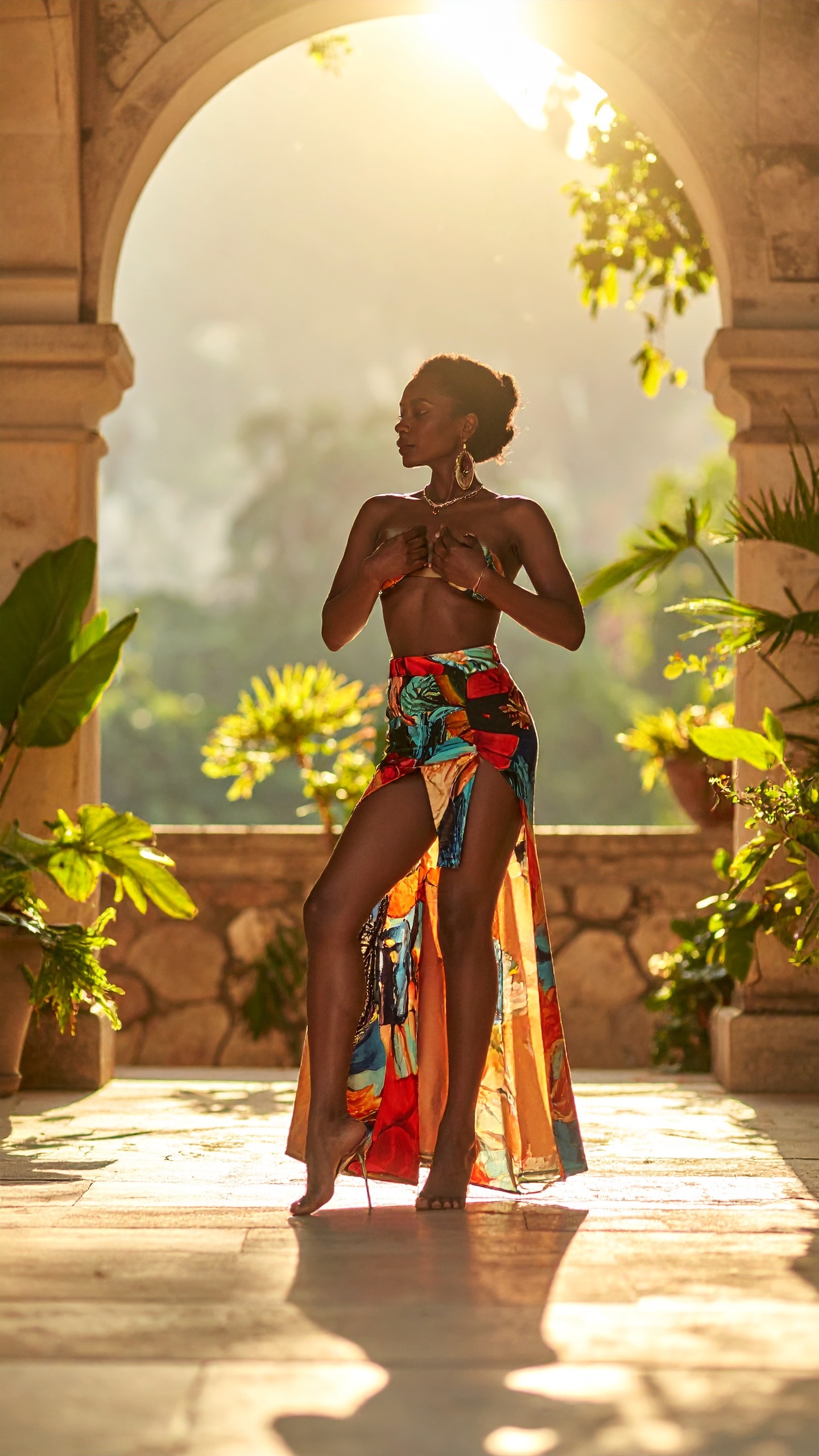 A woman standing in a lit archway, garden bright beyond