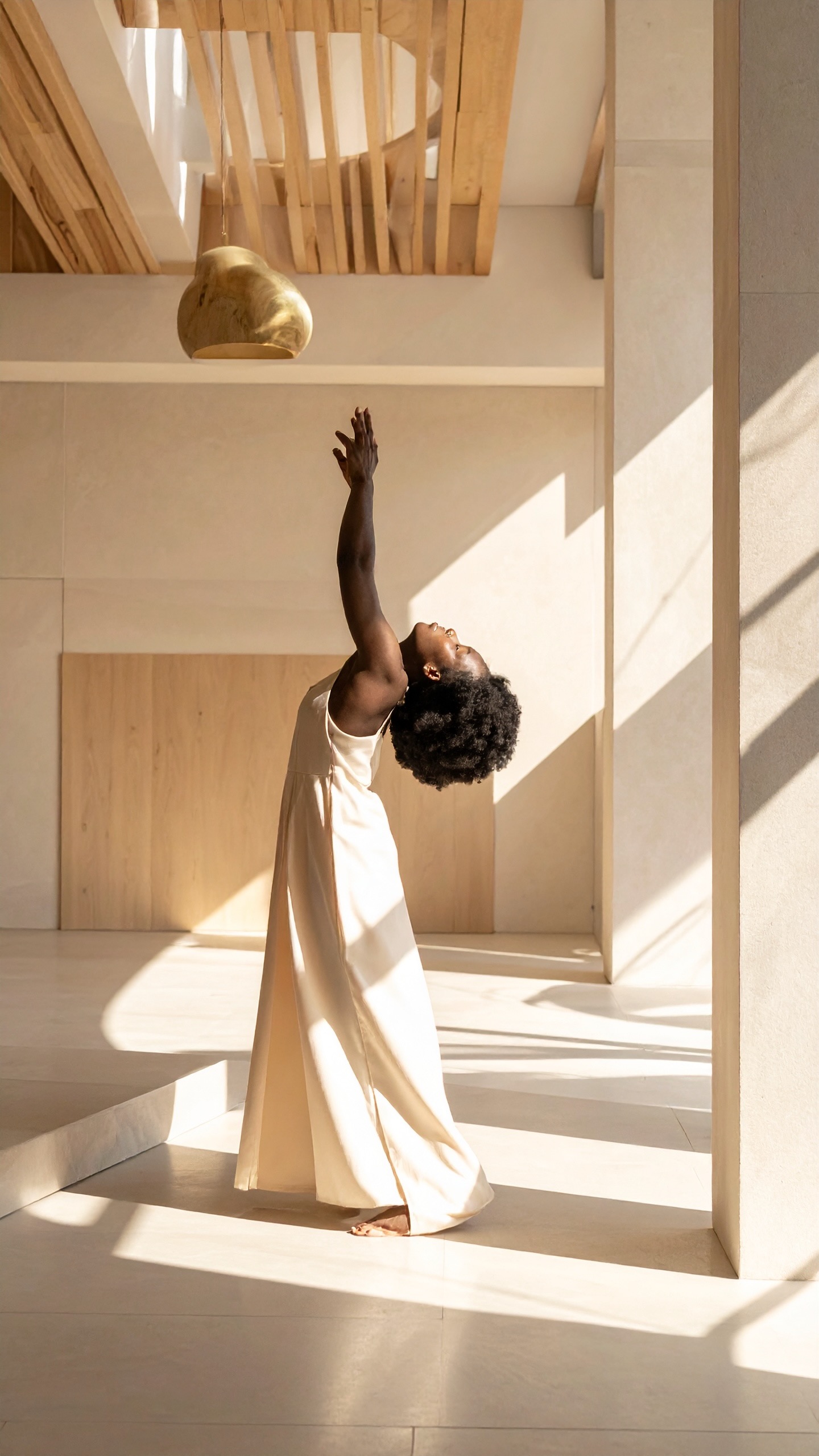 The whole frame, uncropped: a woman arched back, one arm extended into the light