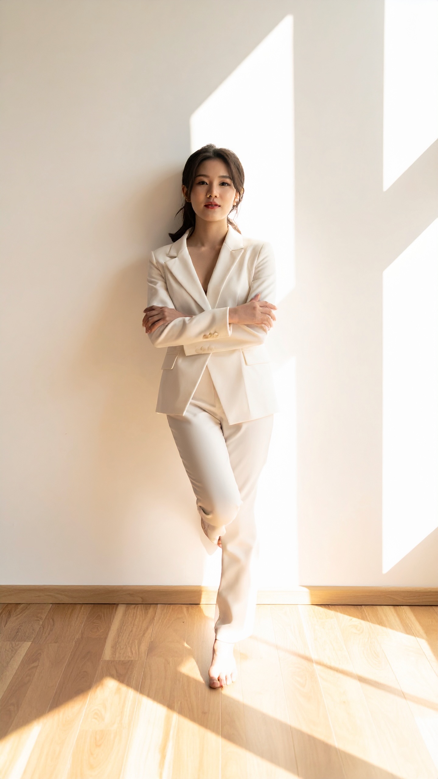 A figure standing at ease against a sunlit wall